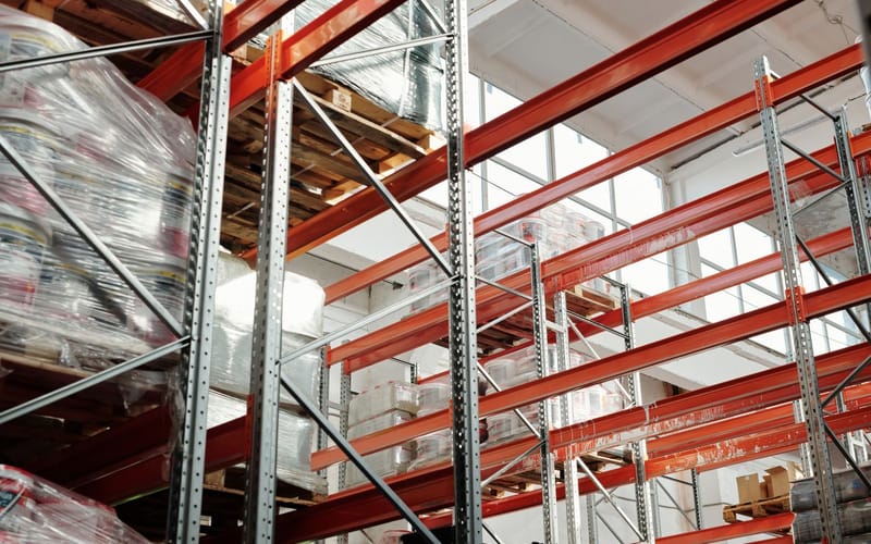 Shrink-wrapped pallets on warehouse racking, ready for dispatch.